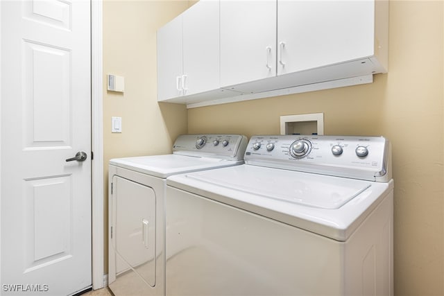 washroom with cabinets and separate washer and dryer