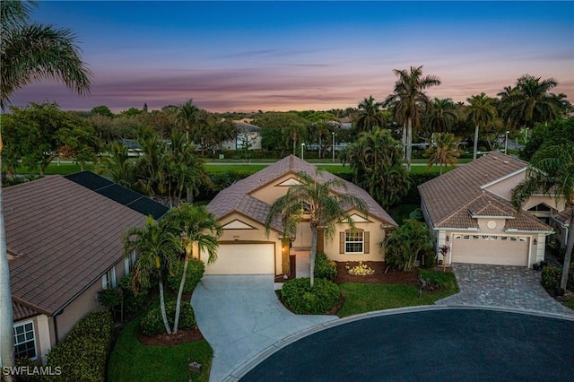 8476 Indian Wells Way, Naples, FL 34113 - mediterranean / spanish-style house featuring an attached garage, concrete driveway, and stucco siding