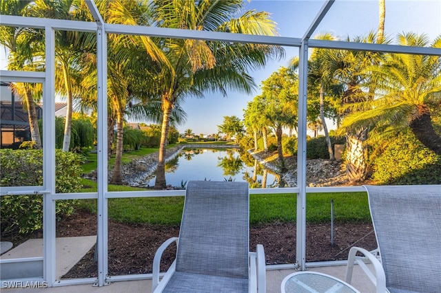 unfurnished sunroom featuring a water view