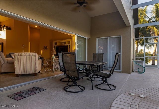 view of patio / terrace with ceiling fan and a lanai