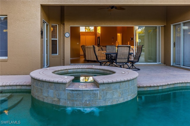 view of pool with ceiling fan, an in ground hot tub, and a patio