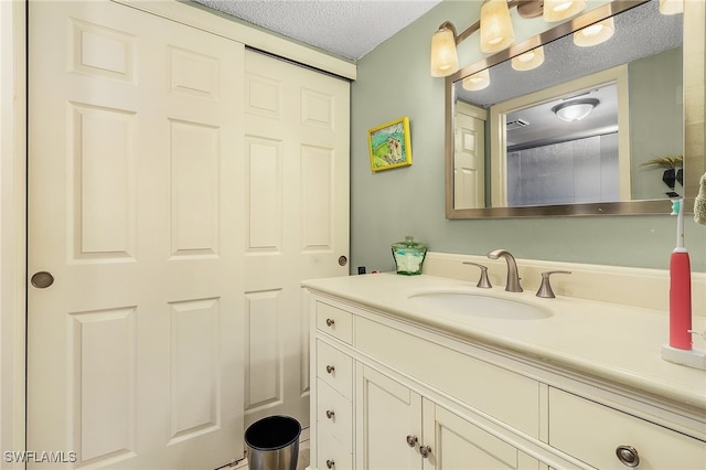 bathroom featuring vanity and a textured ceiling