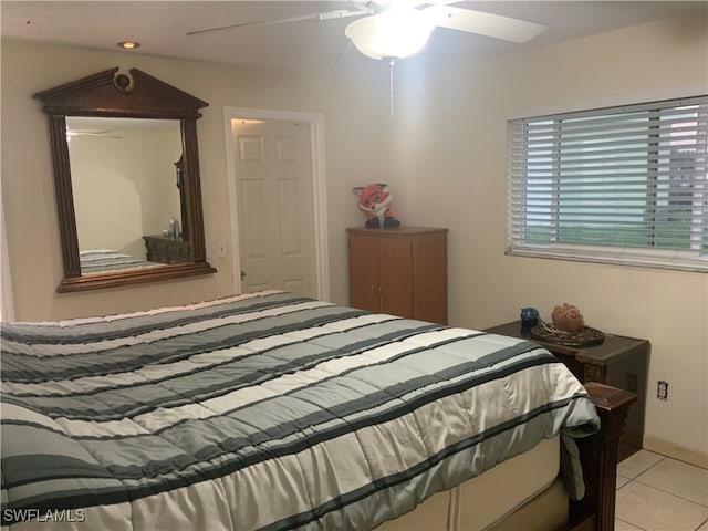 tiled bedroom featuring ceiling fan