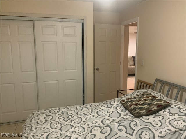 tiled bedroom featuring a closet