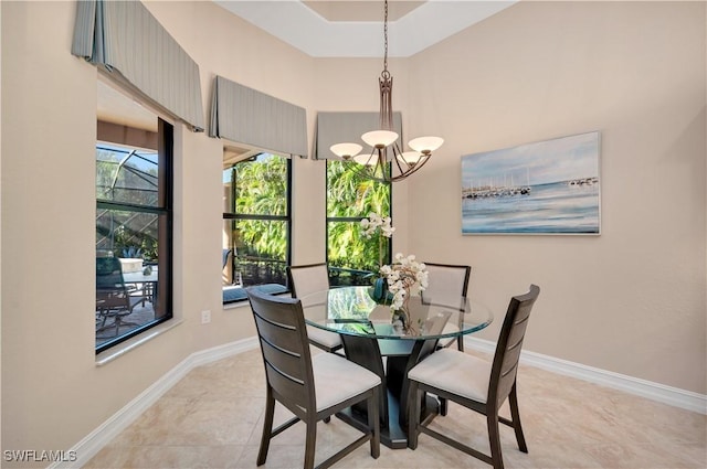 7399 Acorn Way, Naples, FL 34119 - dining space with a chandelier, baseboards, and a towering ceiling