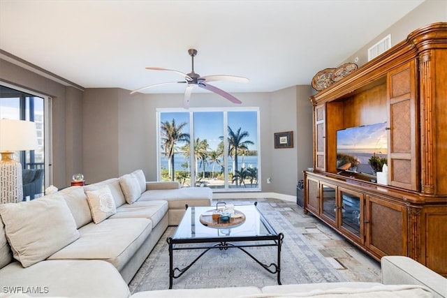 living room with ceiling fan and a healthy amount of sunlight