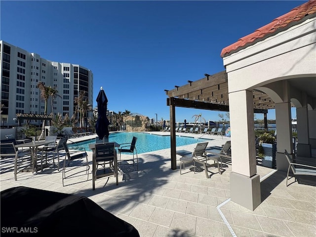 view of pool with a pergola and a patio area