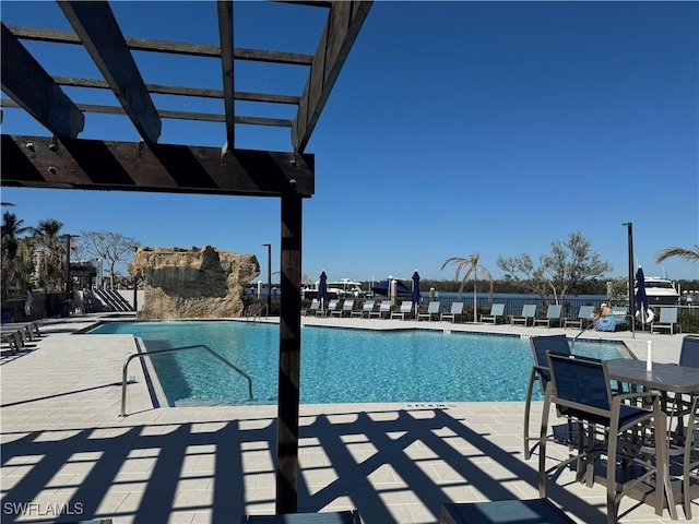 view of swimming pool featuring a patio area and a pergola