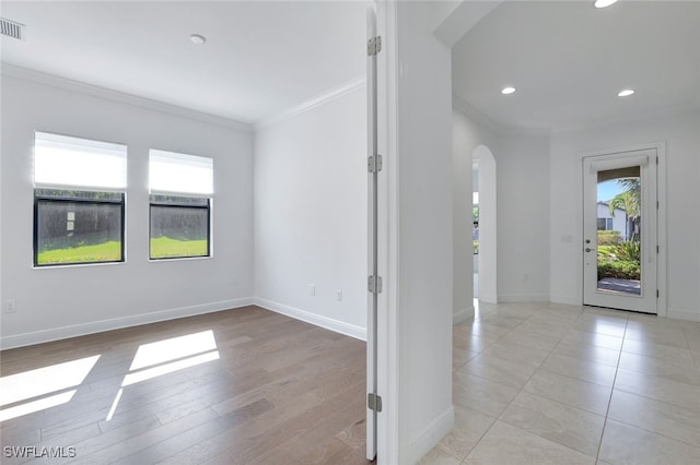 entryway featuring light hardwood / wood-style floors, plenty of natural light, and ornamental molding