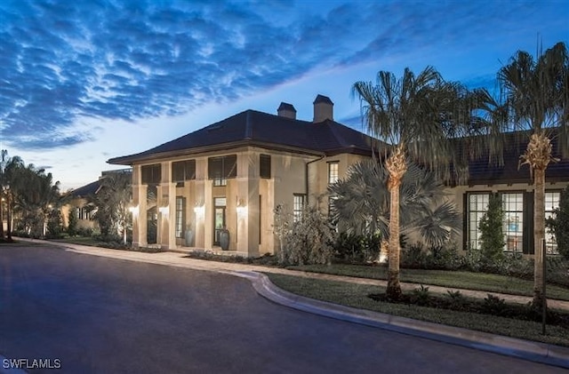 view of outdoor building at dusk