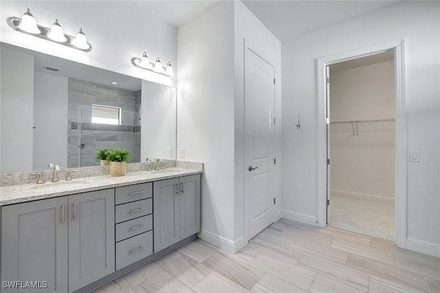 bathroom featuring vanity and a shower with shower door