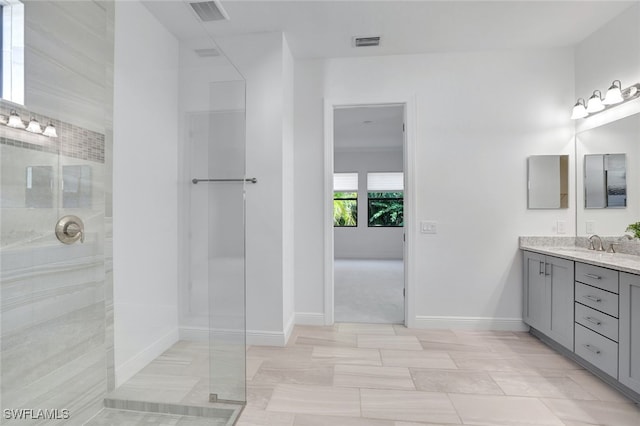 bathroom featuring a shower and vanity