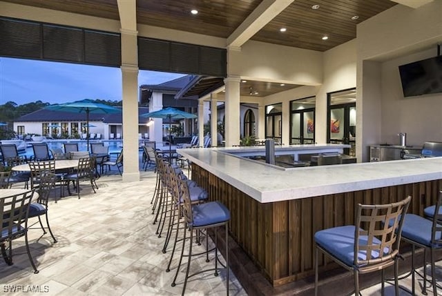 bar featuring beamed ceiling and wooden ceiling