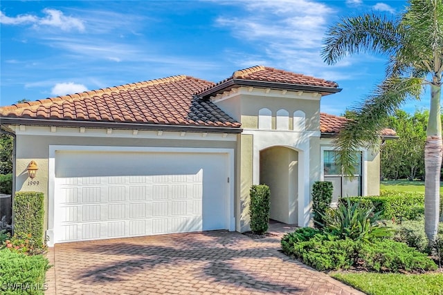 mediterranean / spanish-style house with a garage