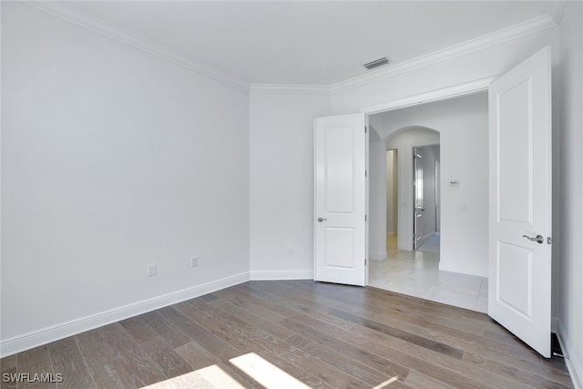 unfurnished room with crown molding and hardwood / wood-style floors