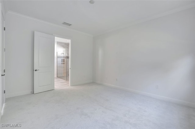 carpeted spare room with ornamental molding