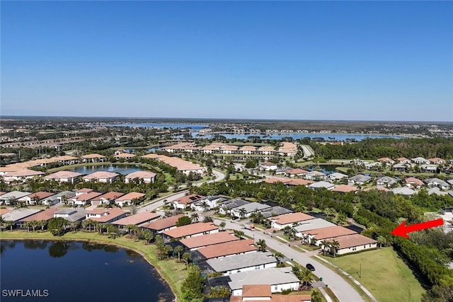 birds eye view of property with a water view