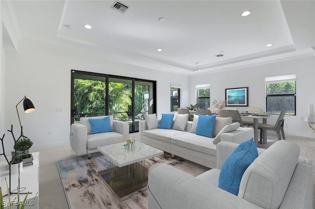 living room featuring ornamental molding and a tray ceiling