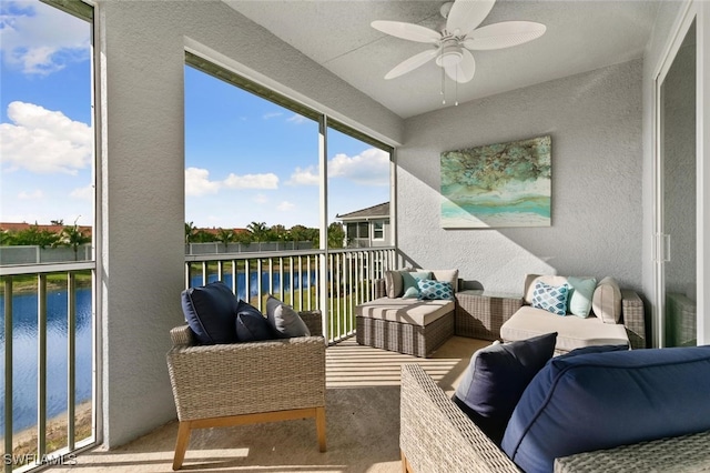 sunroom / solarium with a water view and ceiling fan