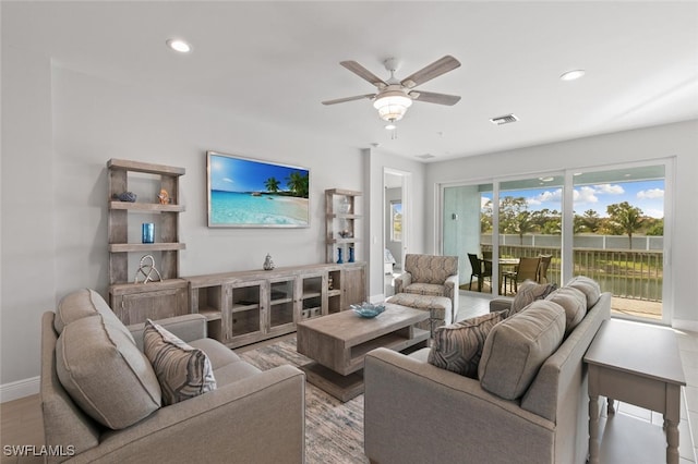 living room featuring ceiling fan and light hardwood / wood-style flooring