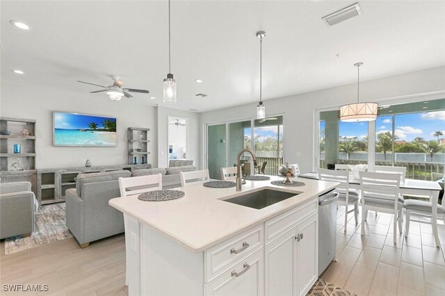 kitchen with a center island with sink, white cabinets, sink, ceiling fan, and light hardwood / wood-style floors