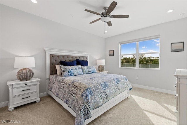 bedroom with ceiling fan and light carpet