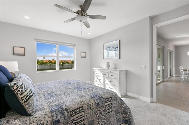 bedroom with light carpet and ceiling fan