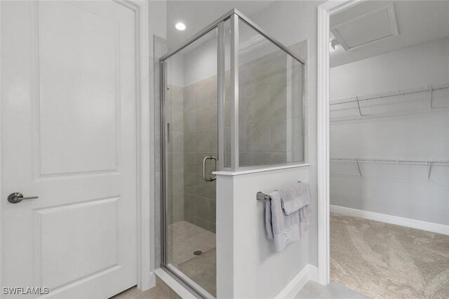 bathroom with a shower with door