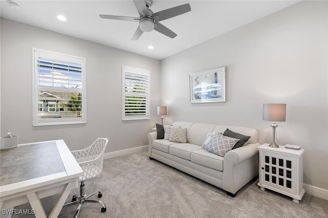 home office with ceiling fan and light carpet