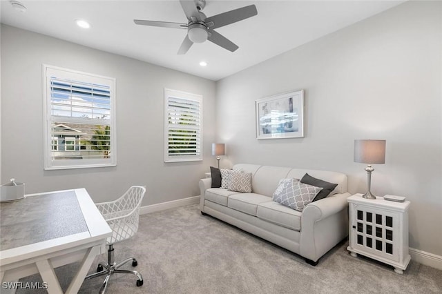 office area featuring light colored carpet and ceiling fan