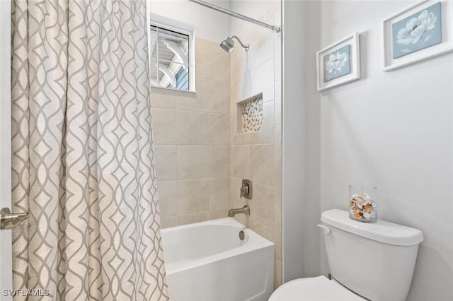 bathroom featuring toilet and shower / tub combo with curtain