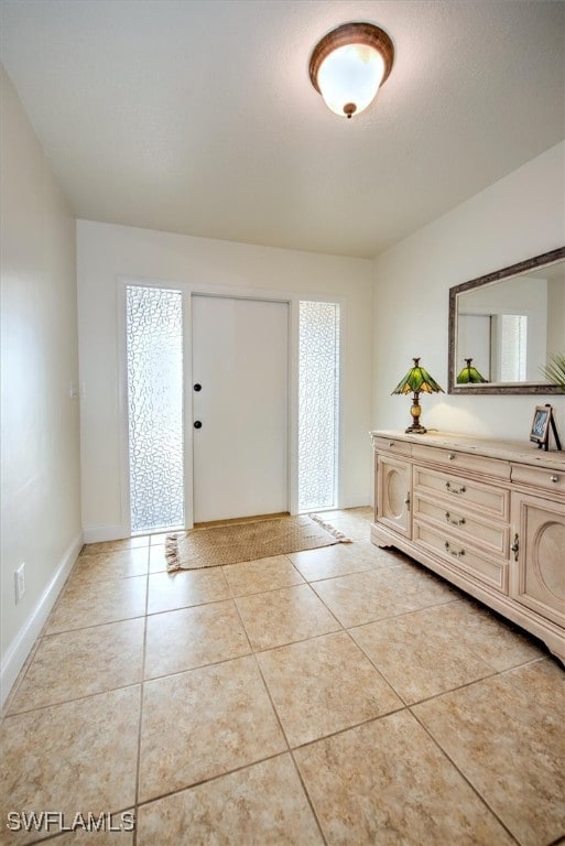 foyer entrance with light tile patterned flooring