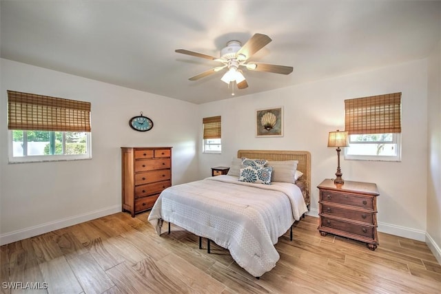 1656 Saint Clair Ave E, North Fort Myers, FL 33903 - bedroom with multiple windows, light wood-style flooring, and baseboards