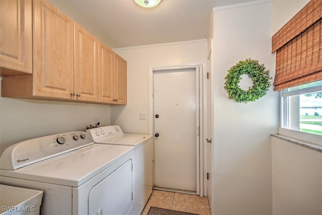 laundry room featuring separate washer and dryer, sink, light tile patterned floors, and cabinets