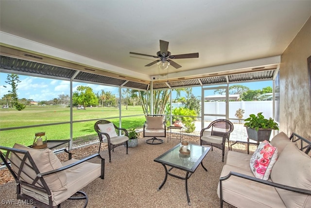 sunroom / solarium featuring ceiling fan