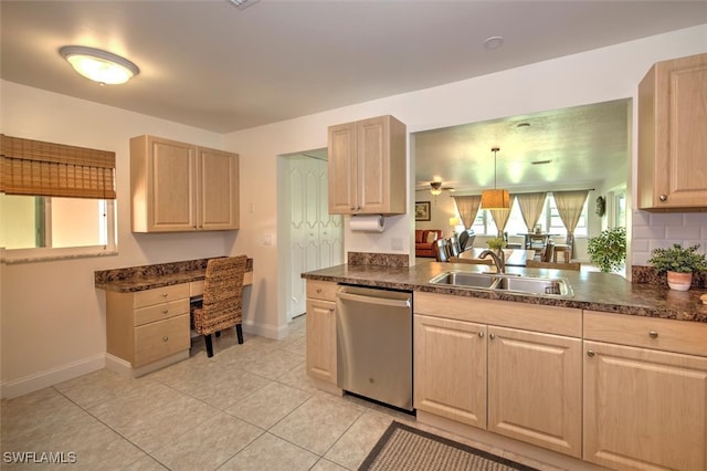 kitchen with pendant lighting, light brown cabinetry, sink, and stainless steel dishwasher