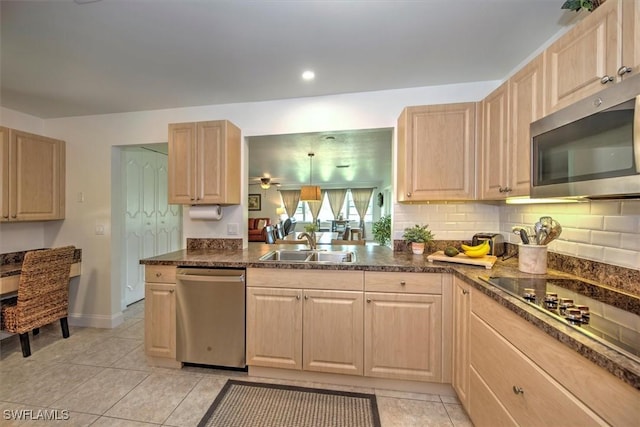 1656 Saint Clair Ave E, North Fort Myers, FL 33903 - kitchen with appliances with stainless steel finishes, light brown cabinets, a sink, dark countertops, and recessed lighting