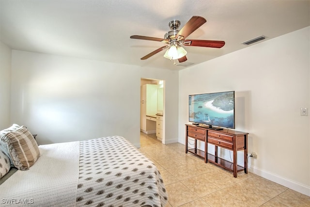 bedroom featuring ceiling fan, light tile patterned floors, and ensuite bathroom