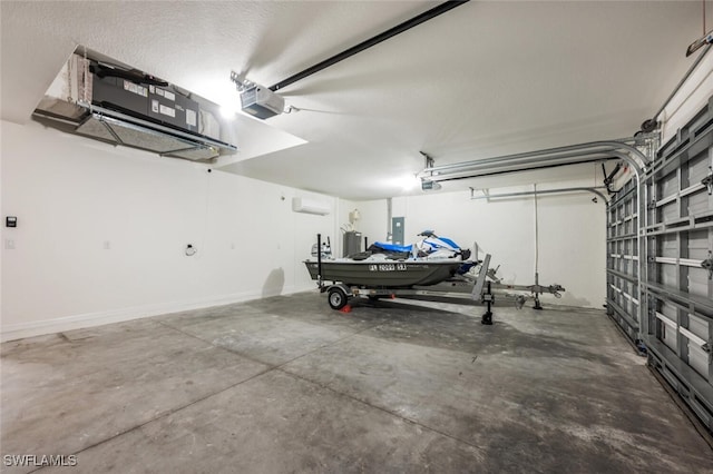 garage with a garage door opener, electric panel, and an AC wall unit