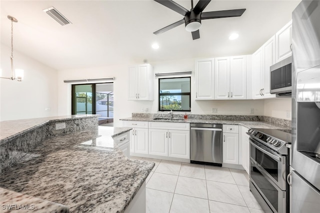 kitchen with white cabinetry, pendant lighting, stainless steel appliances, and light stone counters