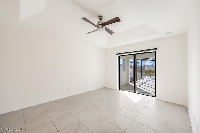 tiled spare room featuring ceiling fan