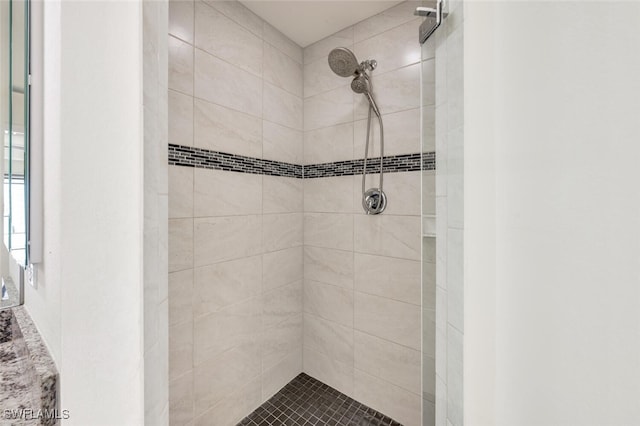 bathroom with tiled shower