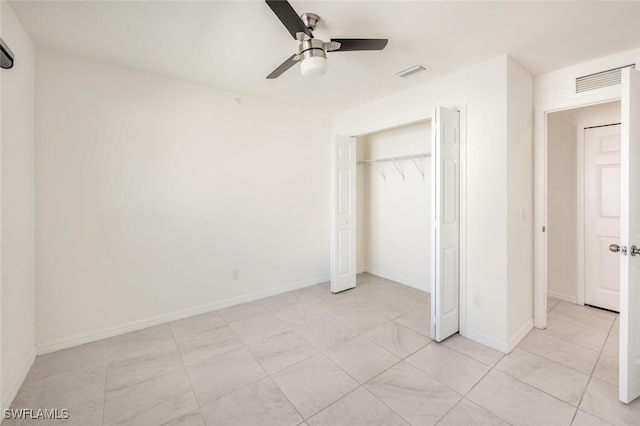 unfurnished bedroom featuring ceiling fan, light tile patterned floors, and a closet