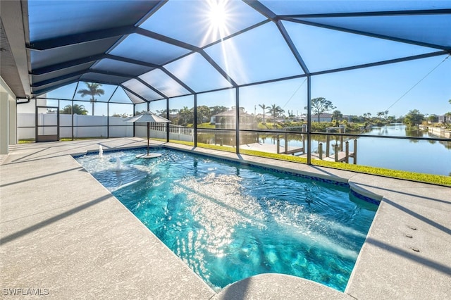 view of swimming pool with a water view, glass enclosure, and a patio area