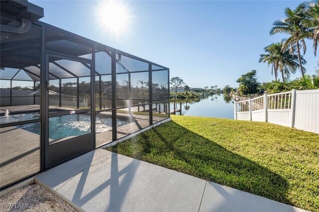 view of yard with glass enclosure, a patio area, and a water view