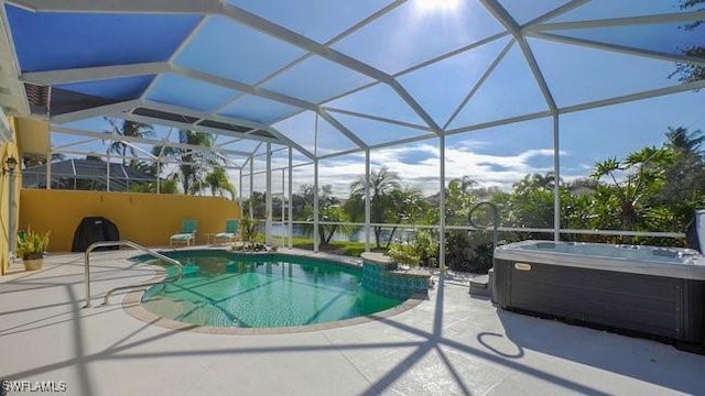 view of swimming pool featuring a lanai, a patio area, and a hot tub