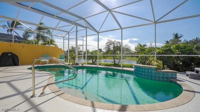 view of pool featuring glass enclosure and a patio area