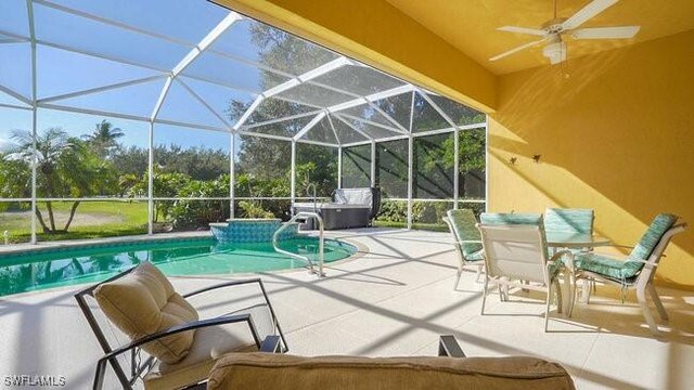 exterior space with ceiling fan, a patio, and glass enclosure