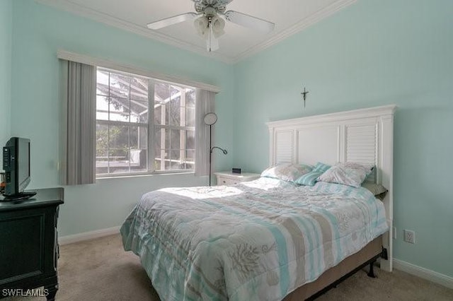 carpeted bedroom with ceiling fan and ornamental molding