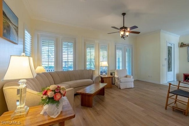 living room with light hardwood / wood-style flooring, ceiling fan, and ornamental molding